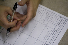 Close-up of a student's hand over a worksheet
